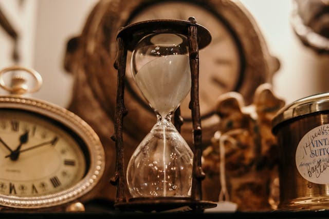 Clock and calendar on a desk representing scheduling