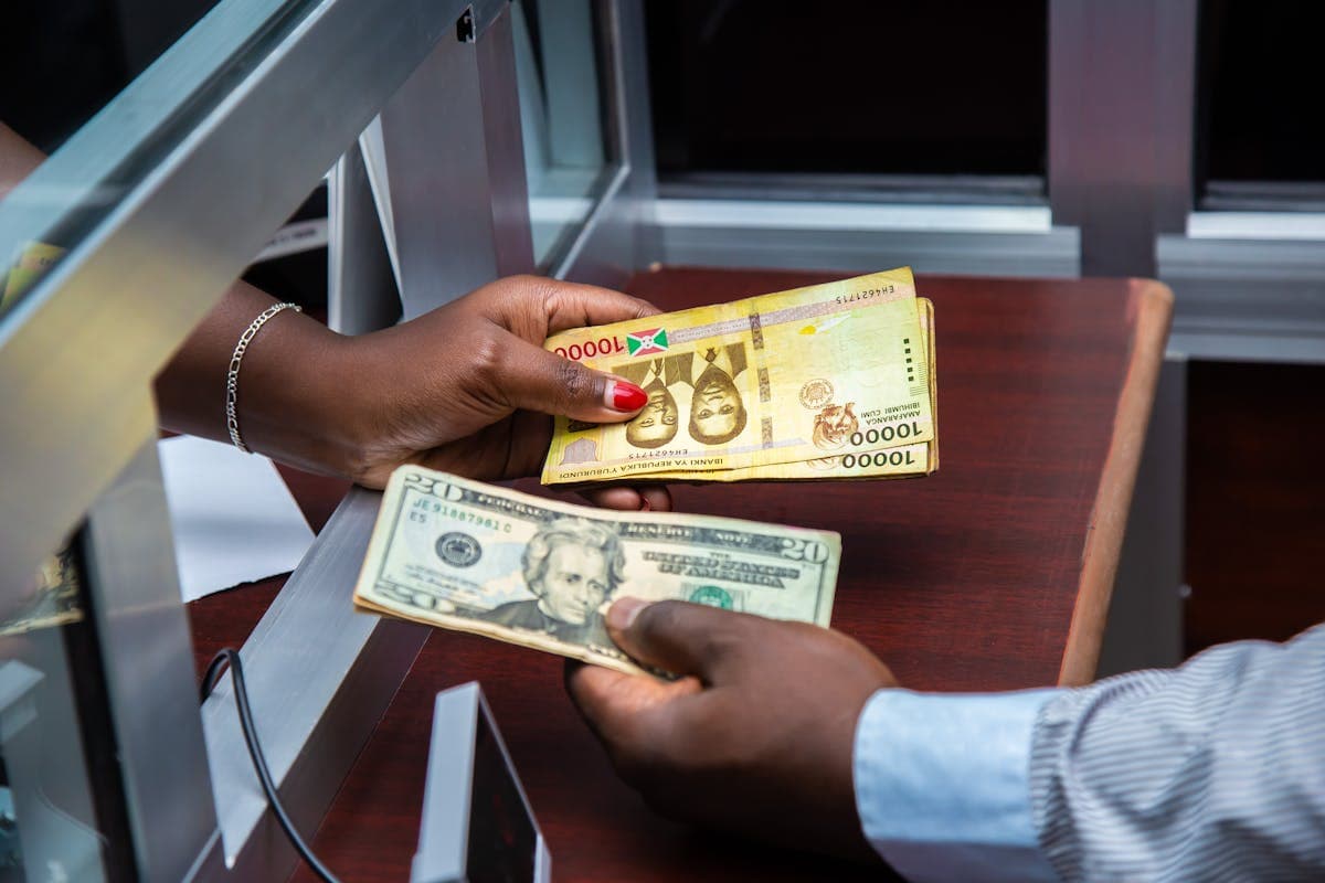 Person checking exchange rates on phone at airport
