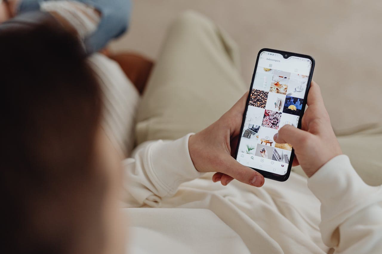 Person scrolling through Instagram on smartphone