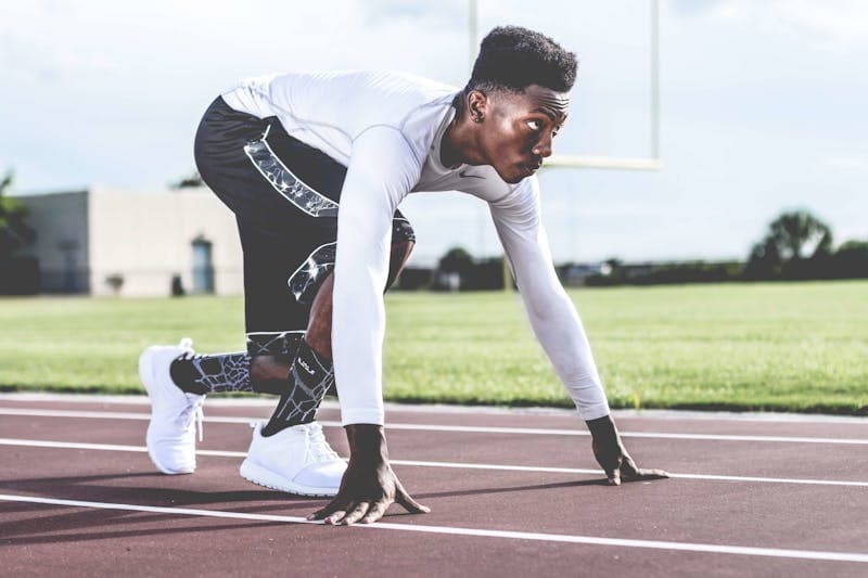Runner checking GPS watch during training