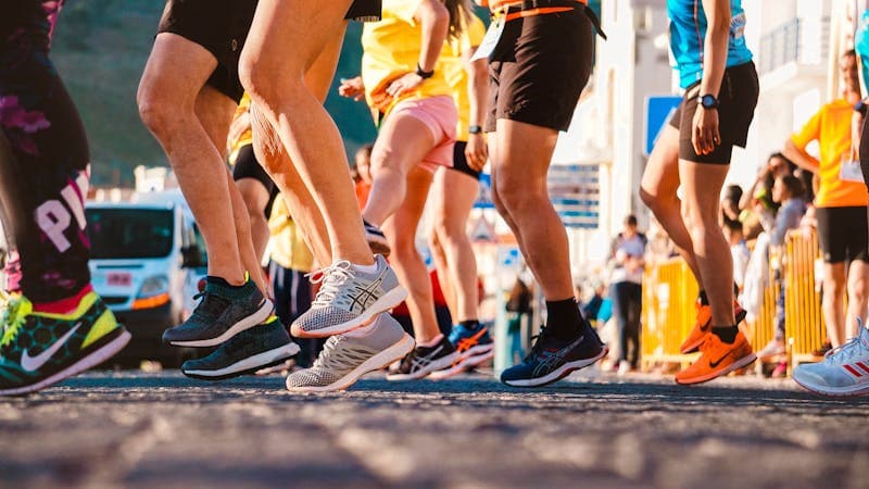 Running shoes on a track with stadium in background