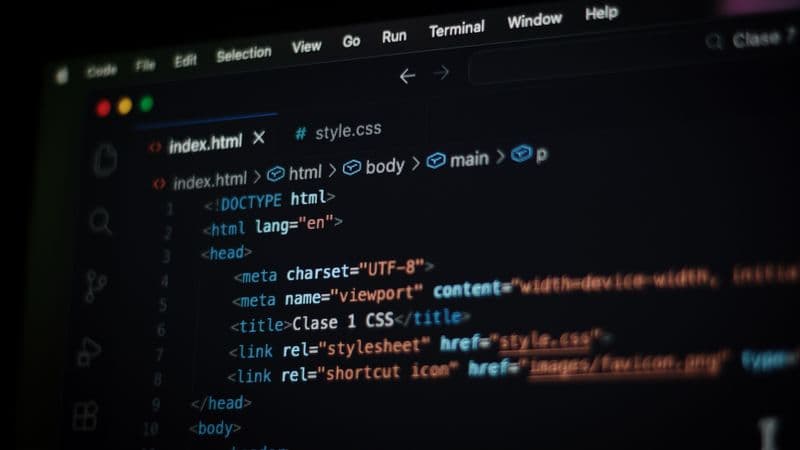 Close-up of HTML code displayed on a computer screen in dark mode, focusing on programming concepts