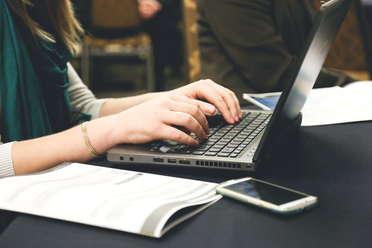 Writer reviewing text with grammar suggestions on screen