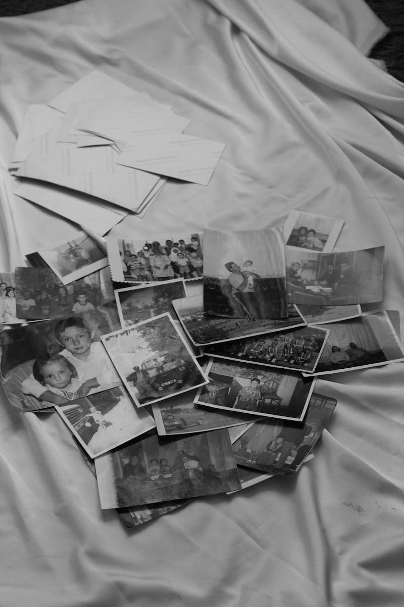 Vintage family photographs spread on wooden table