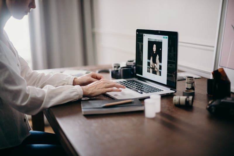 Person editing a photo on a laptop screen