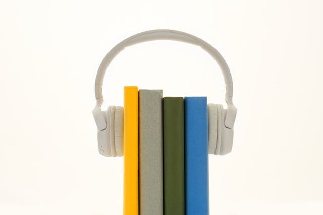 Microphone and headphones on a podcast recording desk