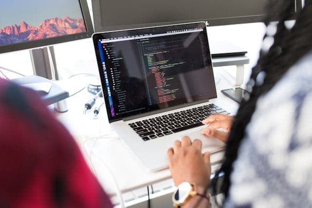 Developer testing an API on a laptop with code editor open