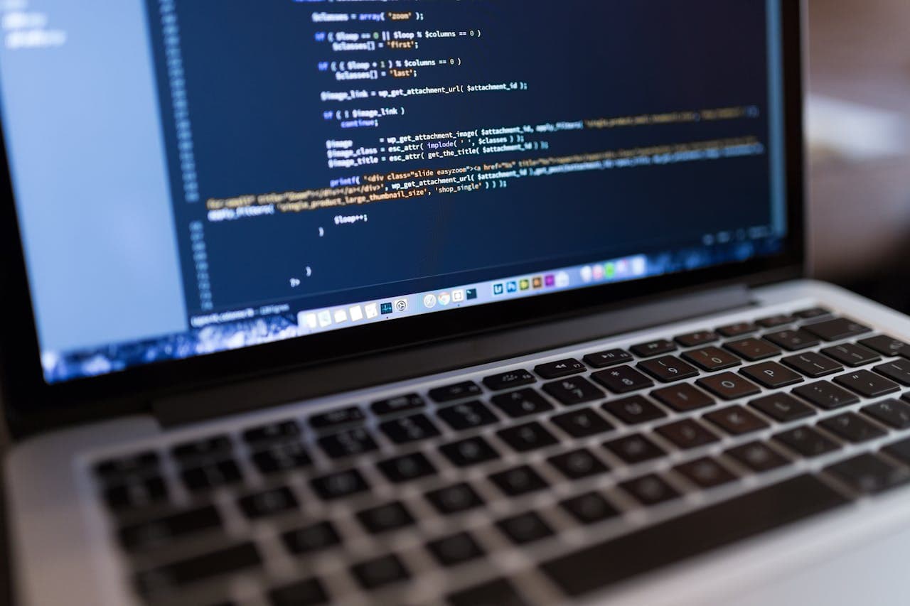 Developer working on laptop with code editor open
