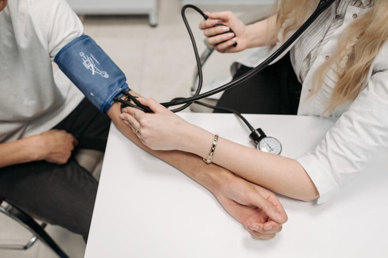 Person checking blood pressure with a home monitor