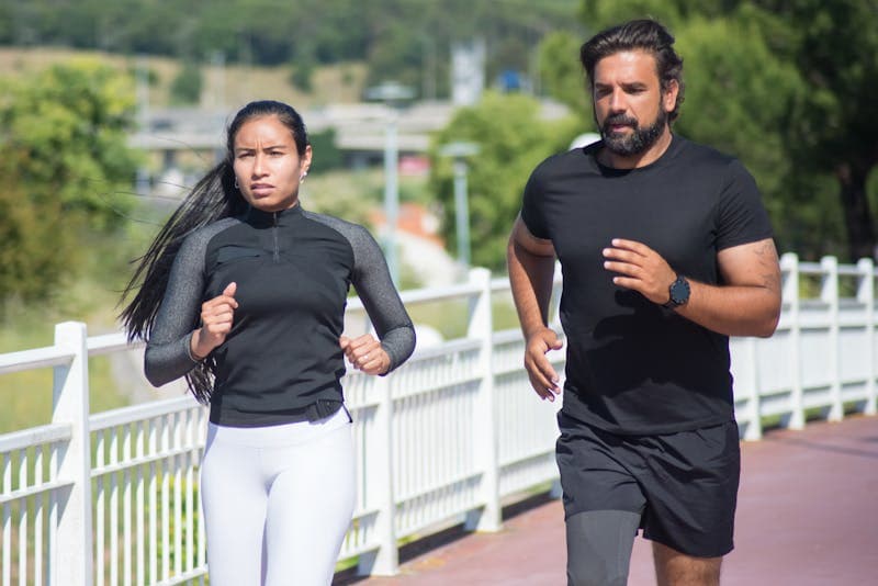 Family exercising together outdoors in a park