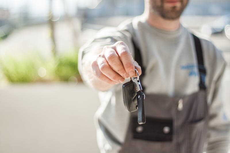 Person researching car prices on laptop
