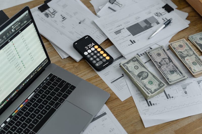 Calculator and financial papers on a desk
