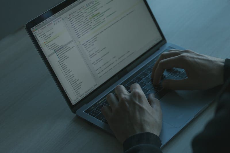 Data analyst cleaning up text files at workstation