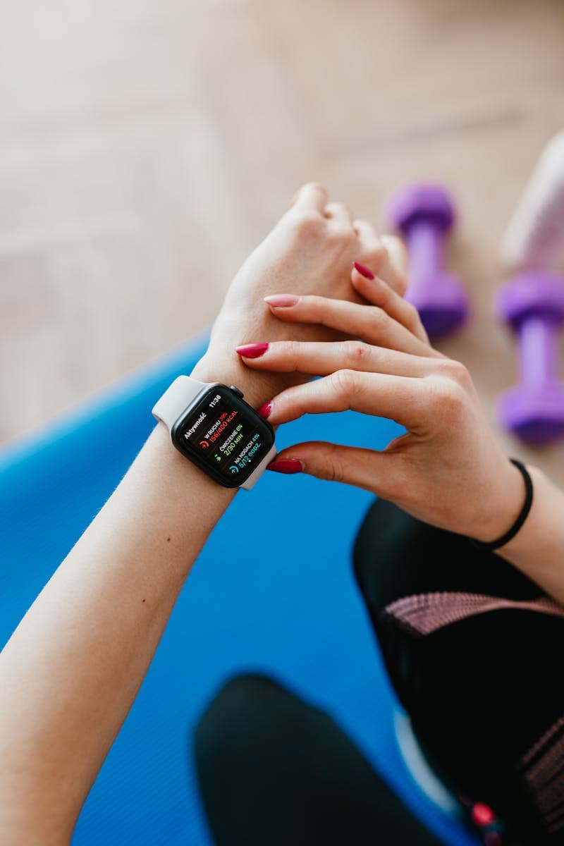 Gym member using stationary bike with heart rate display