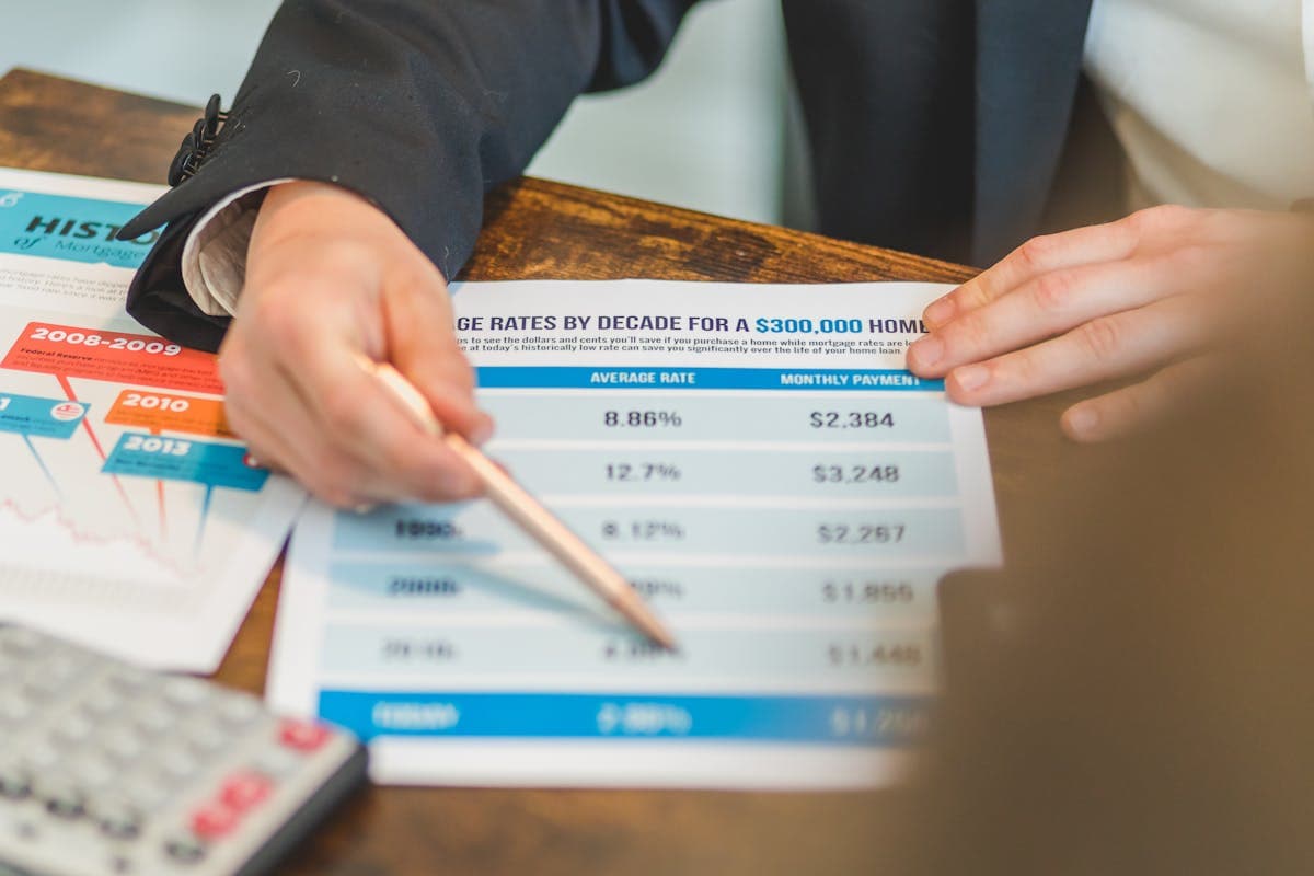Couple reviewing mortgage documents at kitchen table