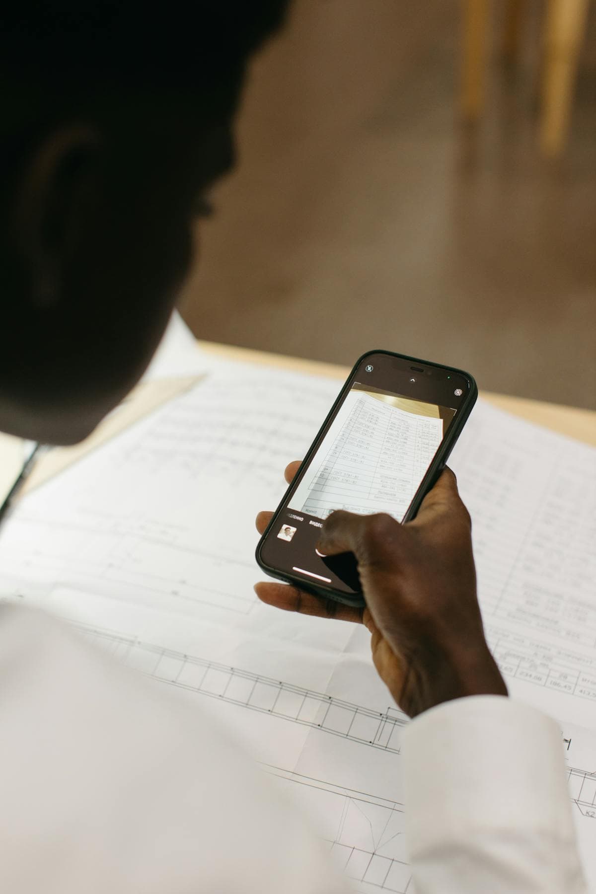 Phone scanning a document with OCR app on screen