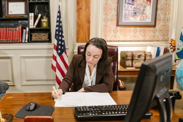 Document with legal text and a laptop on a desk