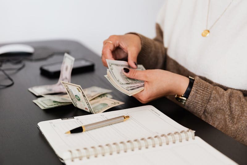 Person reviewing financial documents at a desk
