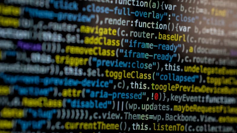 Developer reviewing synthetic test data on multiple screens