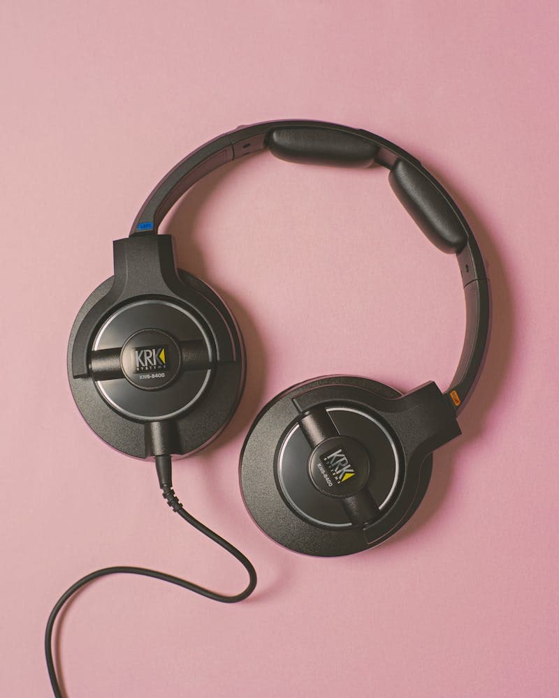 Person listening to content through headphones while looking at a screen