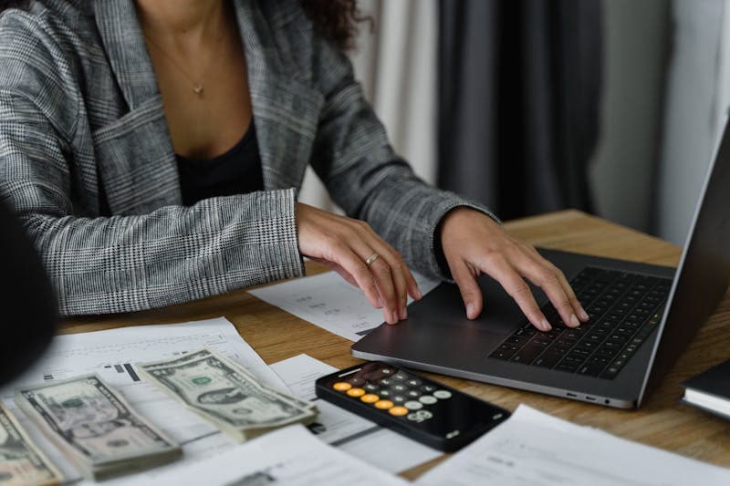 Freelancer working at a desk with a clock on the wall