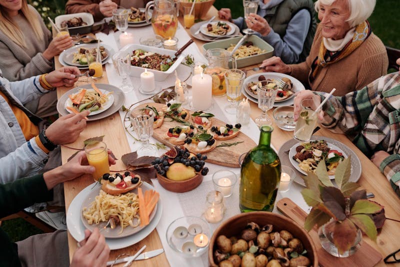 Friends splitting a dinner bill with phones on table