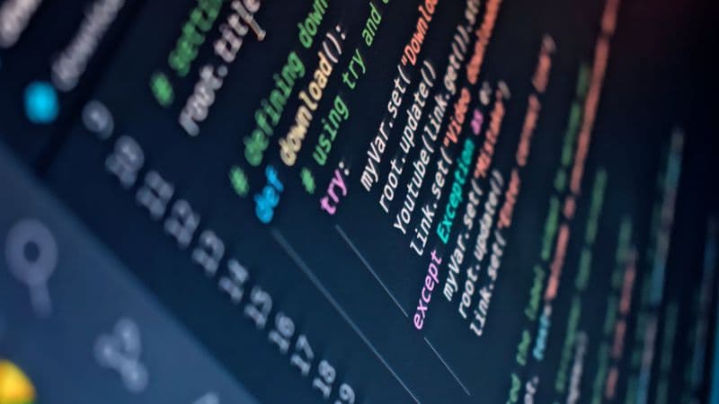 Close-up of a computer screen displaying colorful programming code with depth of field